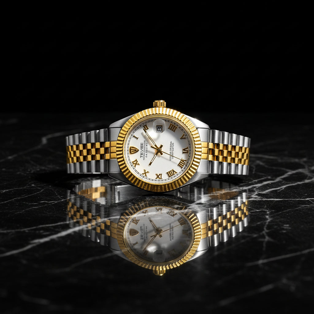 Gold and silver watch with a white face on a white background