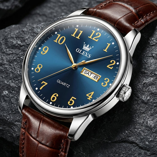 Watch with brown leather strap and blue dial on a dark stone background