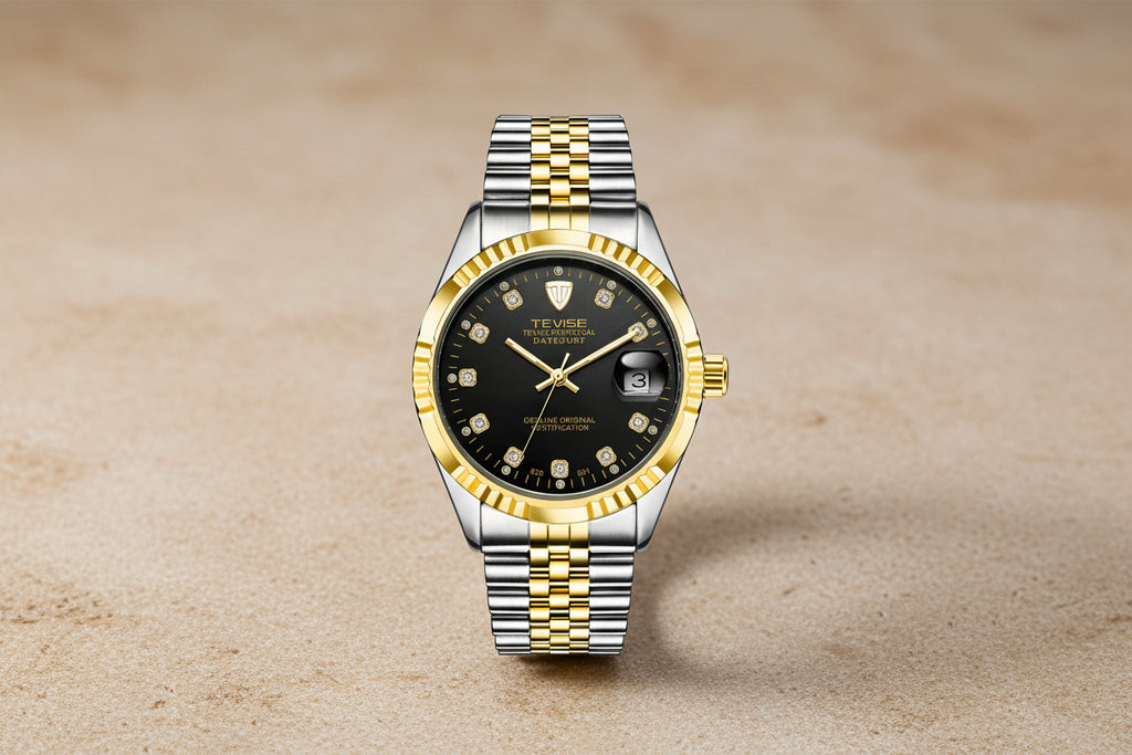 Luxury watch with black dial, gold and silver metal band on white background